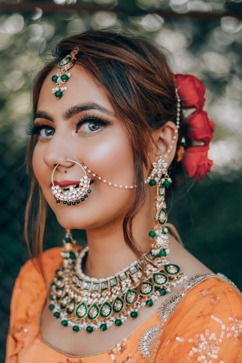 woman in orange and white dress with silver and red flower crown