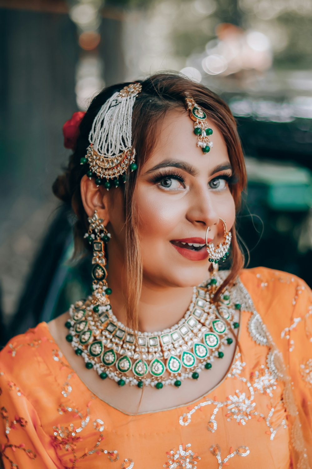 woman in orange and white dress with silver and gold crown