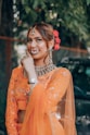 woman in orange dress wearing silver necklace