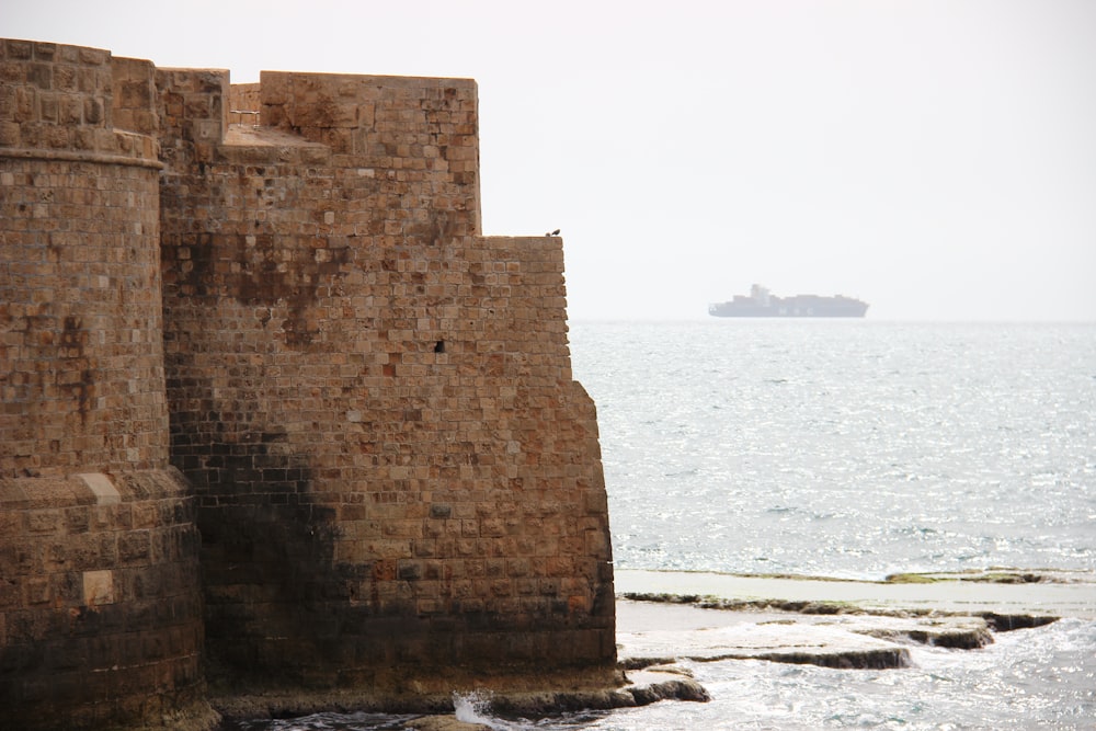 brown concrete building near sea during daytime