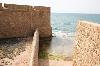 View of the ancient stone walls of the San Giovanni fortress overlooking the bay.