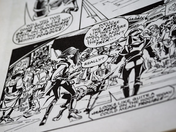 A black-and-white comic panel featuring characters in dialogue. The characters appear to be in a futuristic or fantasy setting, wearing helmets and armor. Speech bubbles convey their conversation, and the background contains other figures and structures.