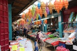 A student exploring a traditional Chinese market, surrounded by colorful lanterns.