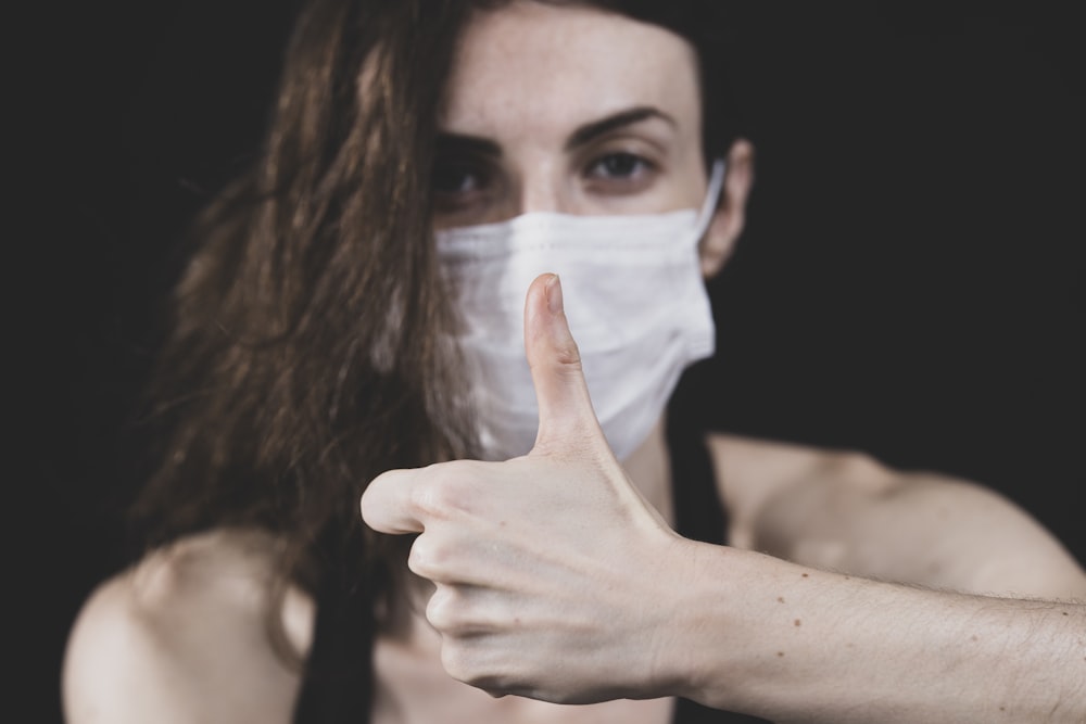 woman covering her face with white paper