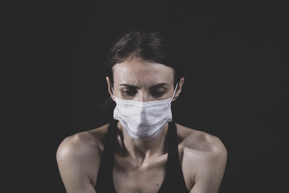woman in black tank top with white face mask