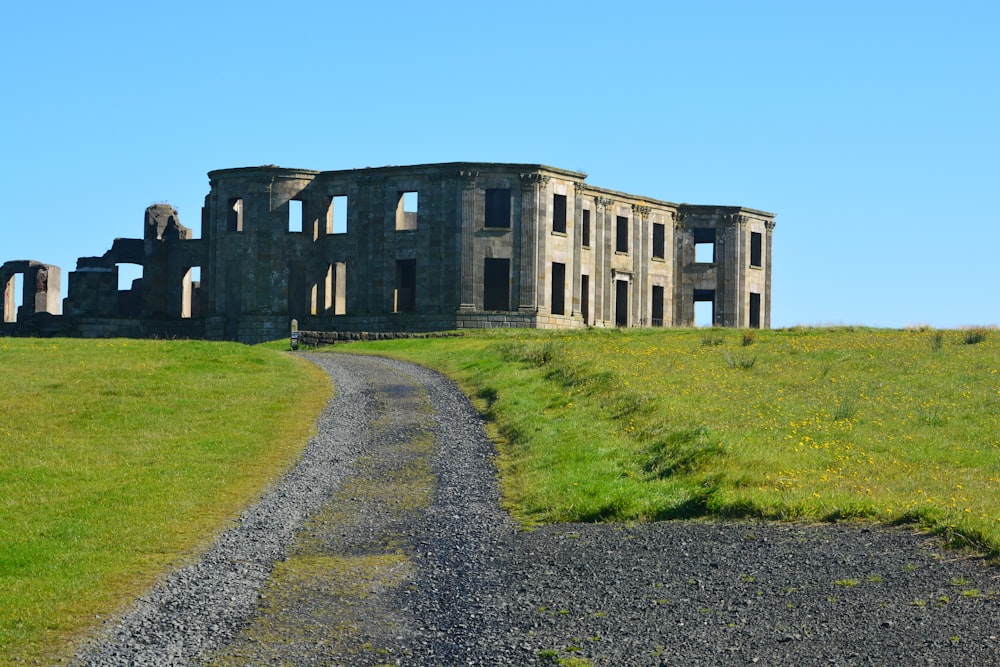 brown concrete building near green grass field during daytime