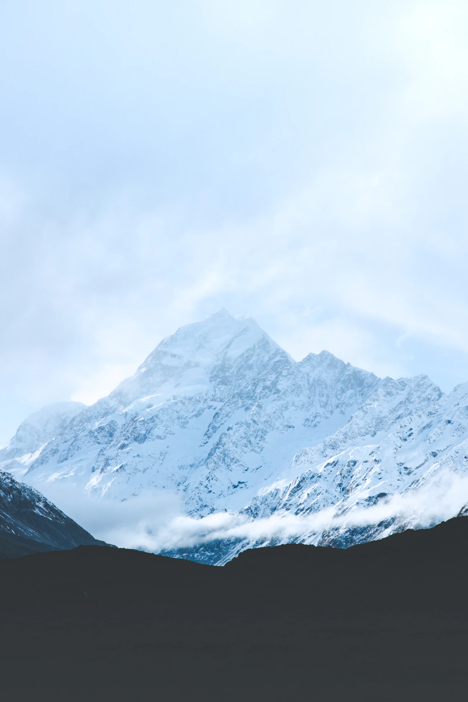 Snow-covered mountain under an overcast sky in New Zealand