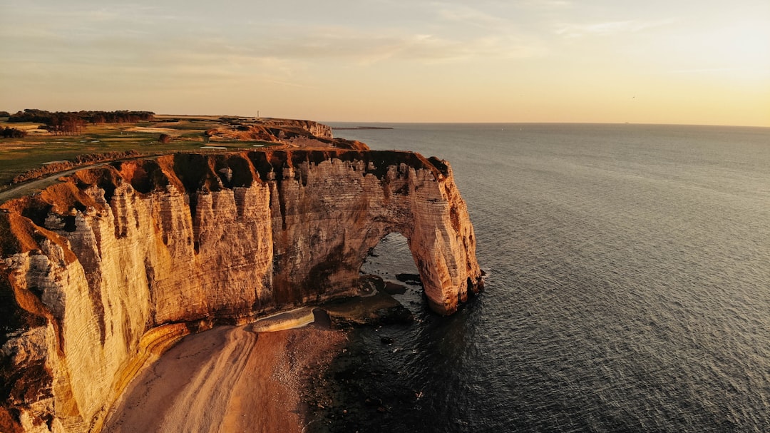 brown rock formation on sea during daytime