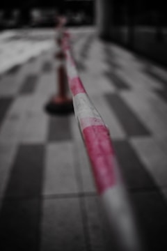 Close-up of a dimly lit crime scene tape with blurred background.