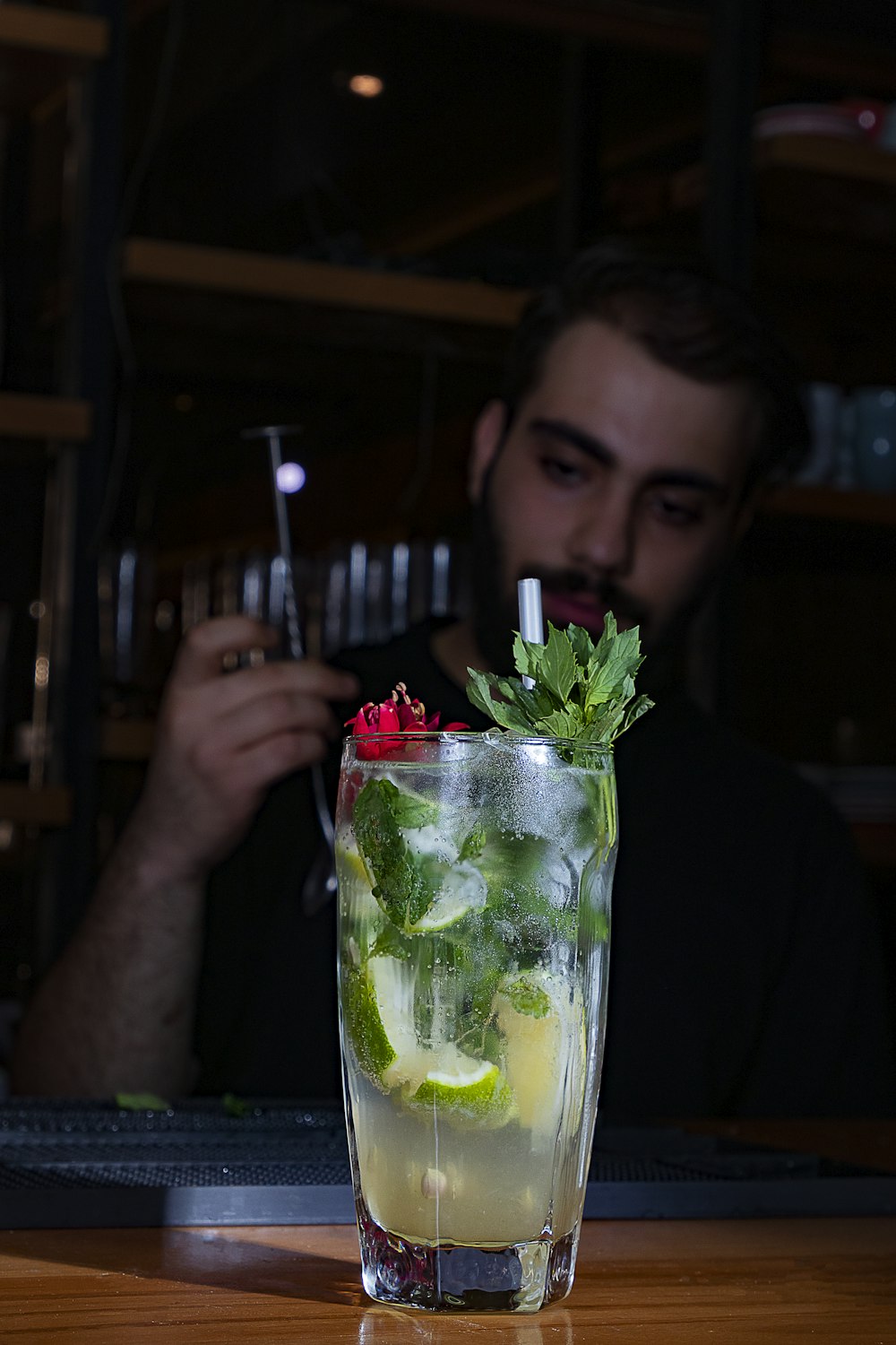 woman holding clear glass cup with green vegetable