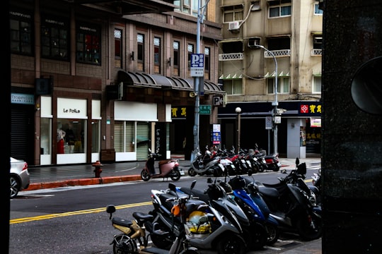 parked motorcycles near building during daytime in Taipei City Taiwan