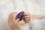 person holding blue plastic hair comb