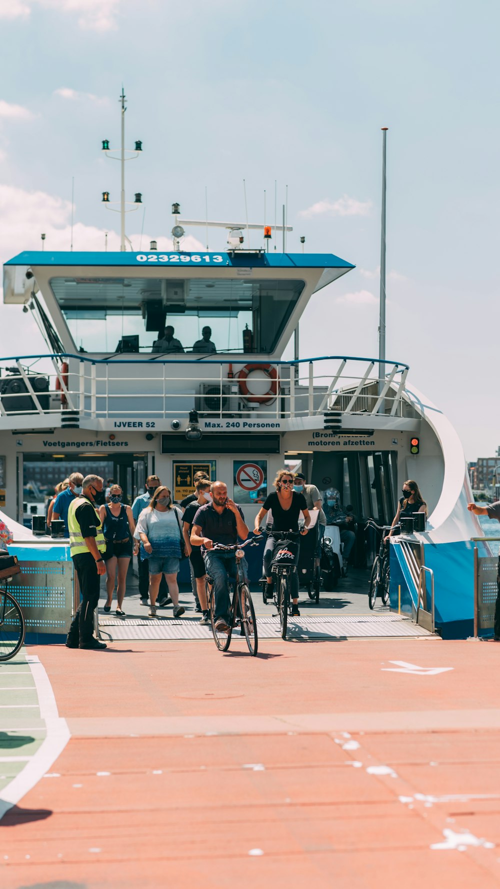 people riding on white and blue boat during daytime