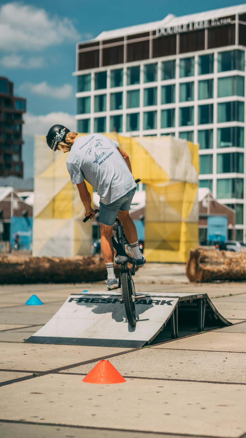 man in white t-shirt riding on bicycle during daytime