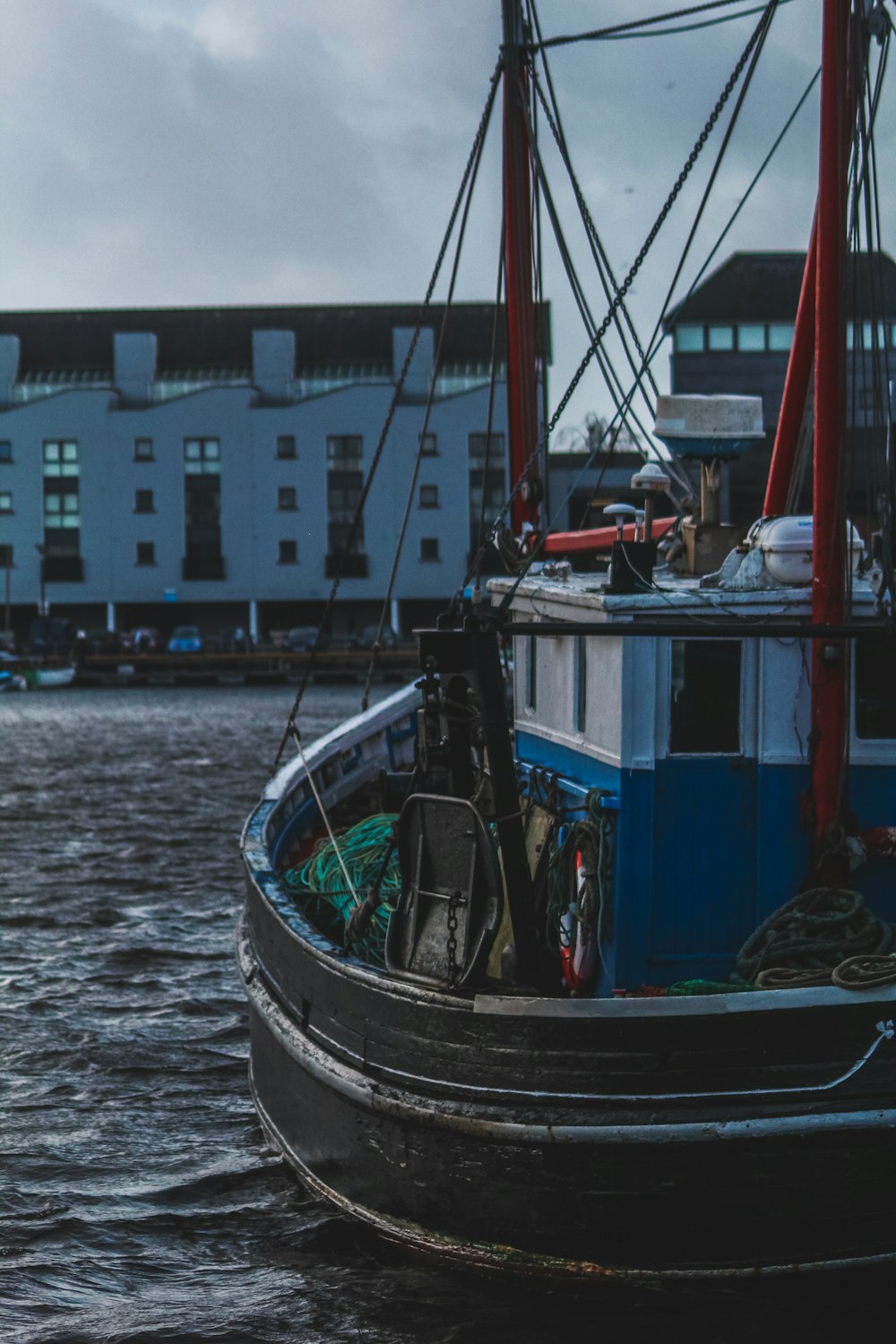 blue and black boat on water during daytime