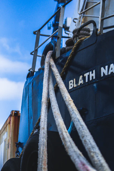 Close-up of a crew member reviewing compliance documents on a tablet aboard a cargo vessel