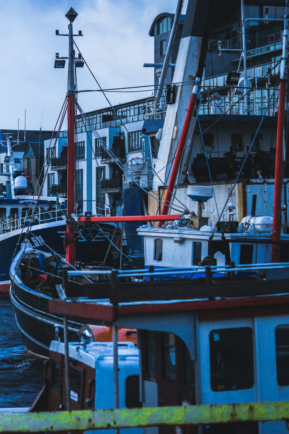 red and green boat on dock during daytime