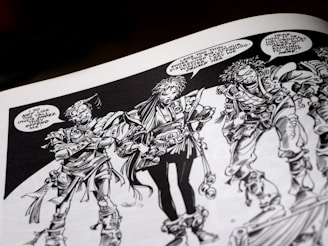 Three intricately drawn characters stand in conversation. Each has unique features and elaborate costumes with a variety of textures. The characters have expressive facial expressions and are engaged in a dialogue with speech bubbles indicating a lively exchange. The artwork is monochromatic, relying heavily on black and white shading.
