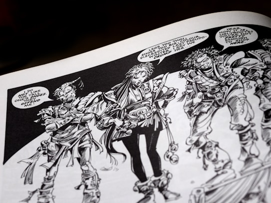 Three intricately drawn characters stand in conversation. Each has unique features and elaborate costumes with a variety of textures. The characters have expressive facial expressions and are engaged in a dialogue with speech bubbles indicating a lively exchange. The artwork is monochromatic, relying heavily on black and white shading.