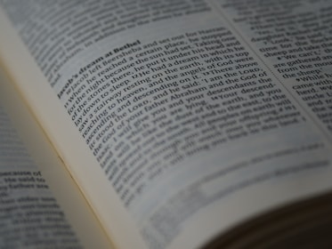 A close-up view of an open book displaying a passage of text in English. The book is arranged in columns, and the text appears to be printed clearly on an off-white page. The focus is on a section of the text, conveying a sense of depth and highlighting readability.