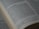 A close-up view of an open book displaying a passage of text in English. The book is arranged in columns, and the text appears to be printed clearly on an off-white page. The focus is on a section of the text, conveying a sense of depth and highlighting readability.