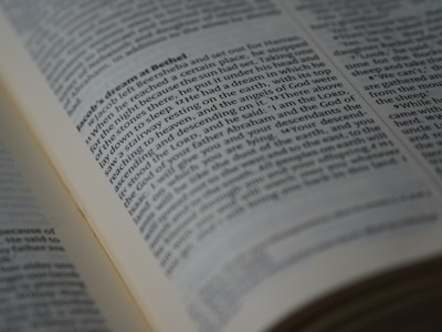 A close-up view of an open book displaying a passage of text in English. The book is arranged in columns, and the text appears to be printed clearly on an off-white page. The focus is on a section of the text, conveying a sense of depth and highlighting readability.