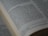A close-up view of an open book displaying a passage of text in English. The book is arranged in columns, and the text appears to be printed clearly on an off-white page. The focus is on a section of the text, conveying a sense of depth and highlighting readability.