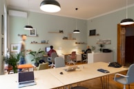 Modern office space with olive-green decor and cotton-related charts on screens.