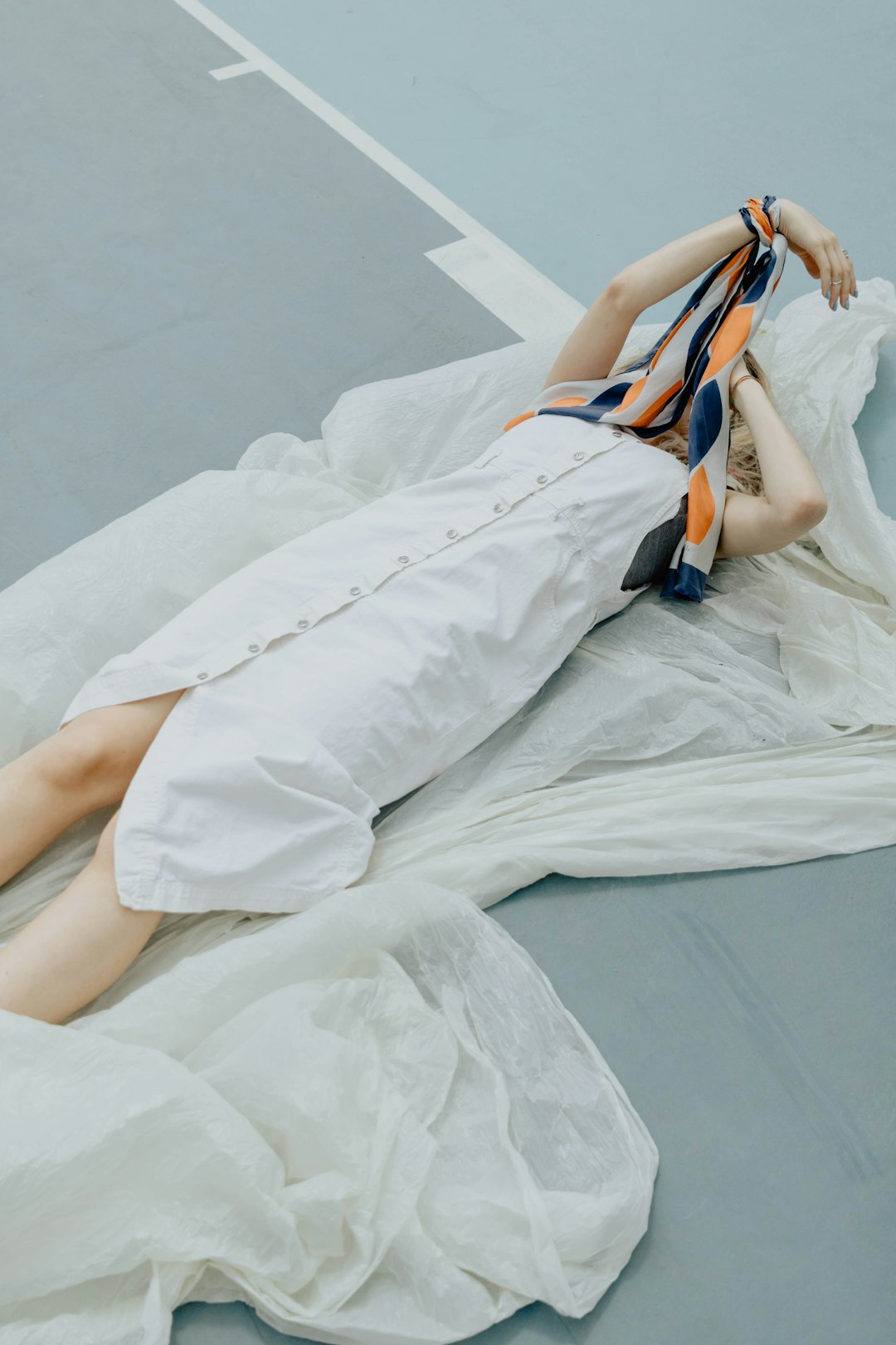 woman in white dress lying on bed