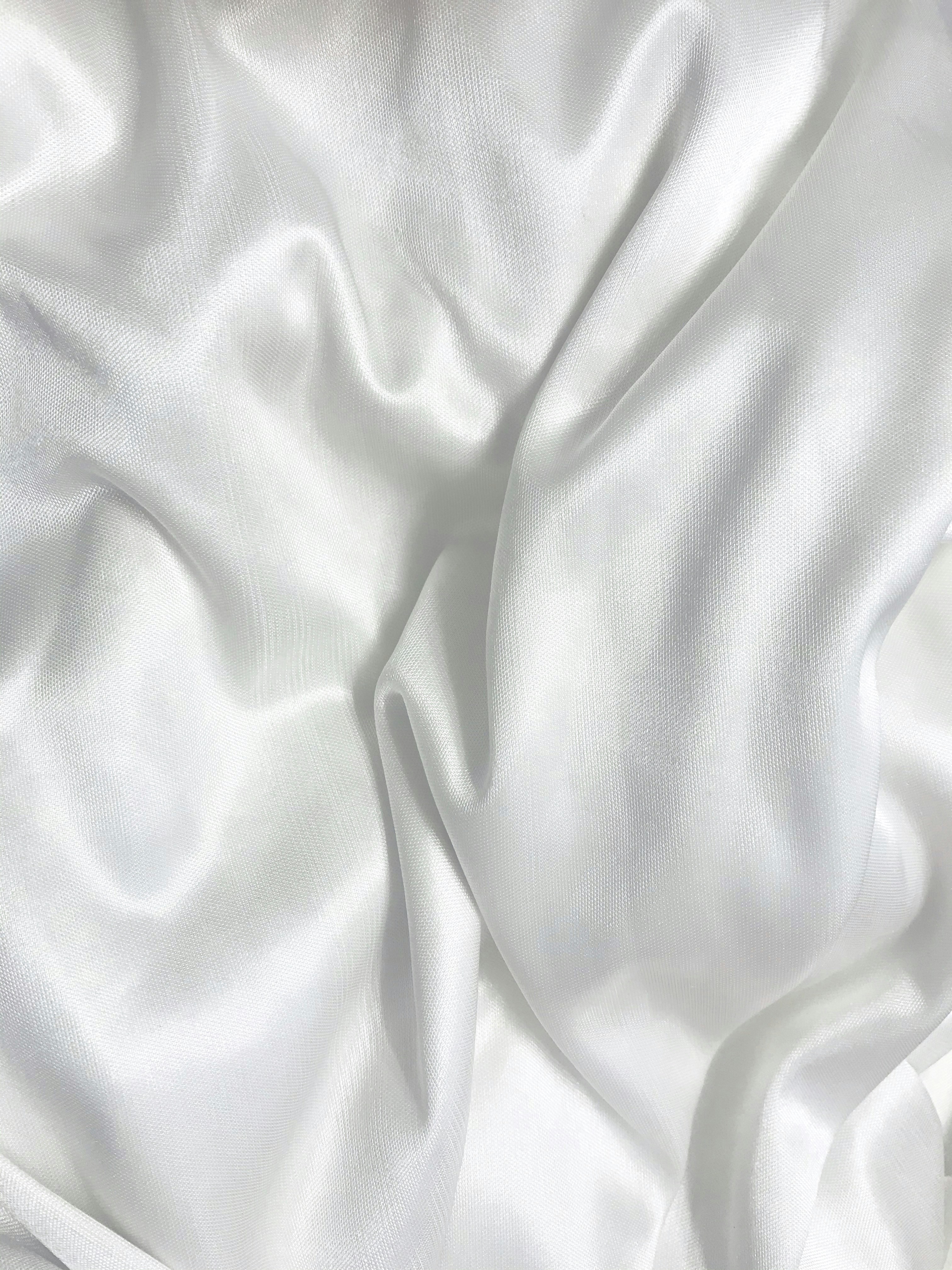 white textile on brown wooden table