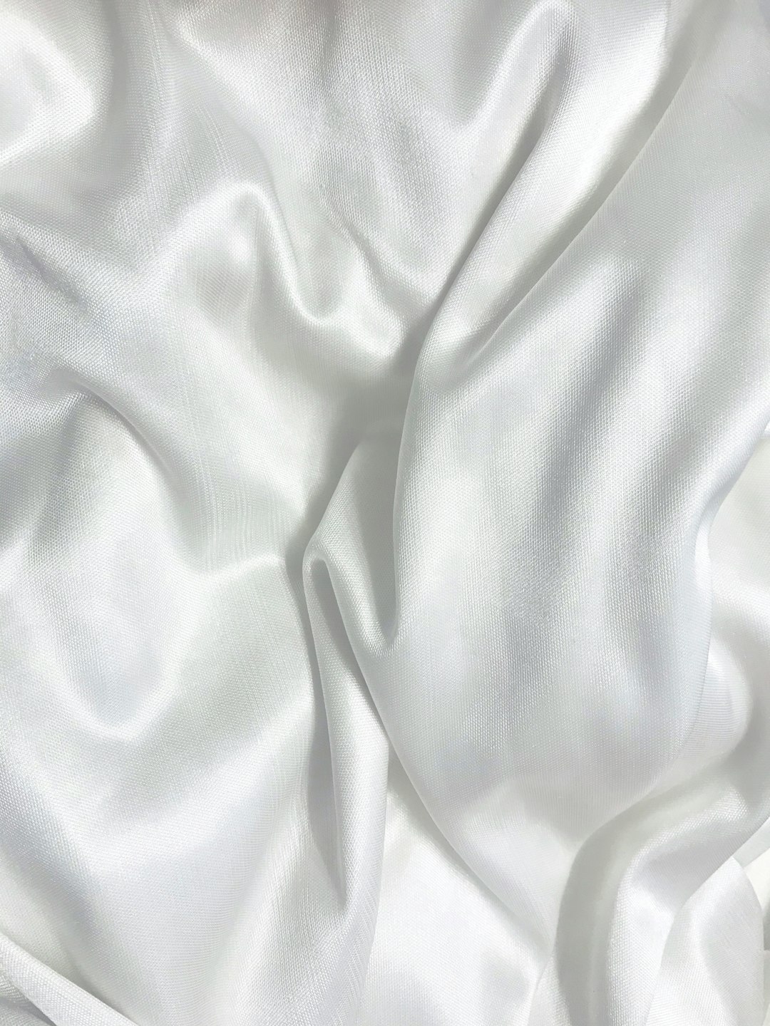  white textile on brown wooden table sheet