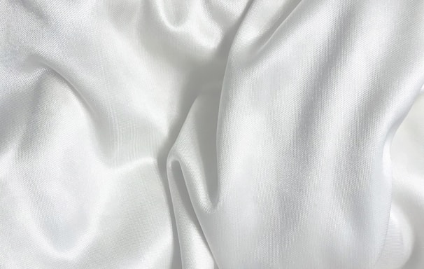 white textile on brown wooden table