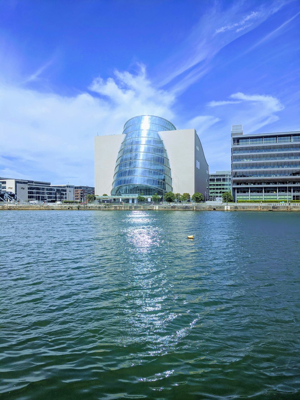 white concrete building near body of water during daytime