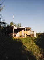 Close-up of a camper van awning installed, shading a picnic setup outside.