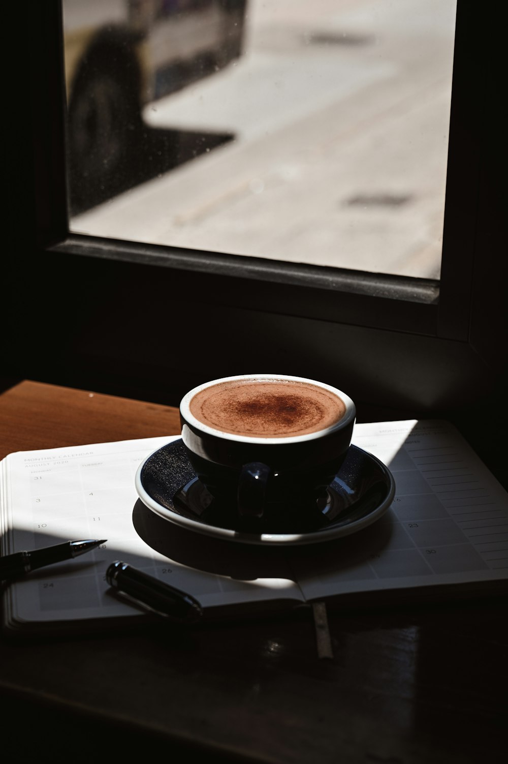 black ceramic cup on saucer