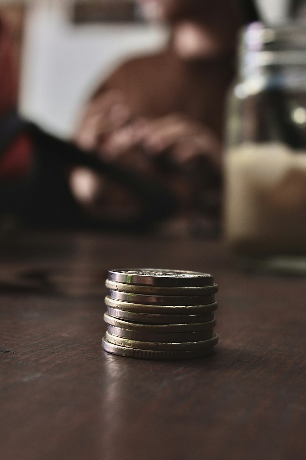 silver and gold round coins on brown wooden table