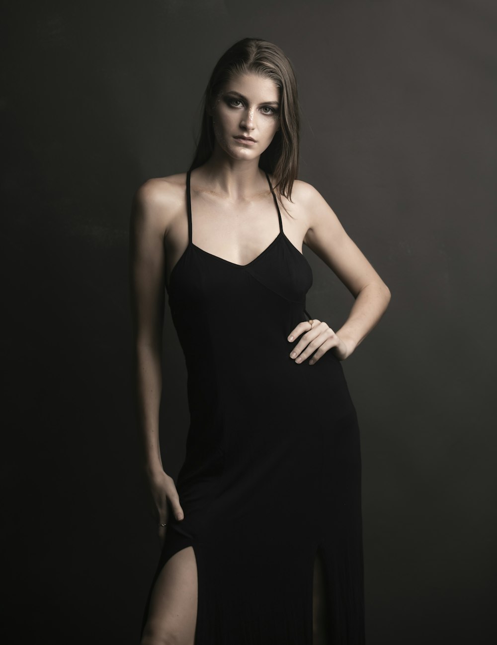 woman in black spaghetti strap dress