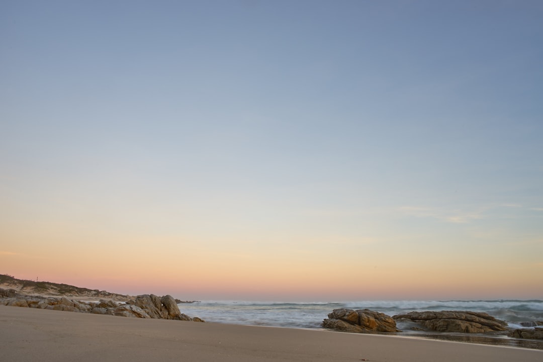 brown rock formation on sea shore during daytime