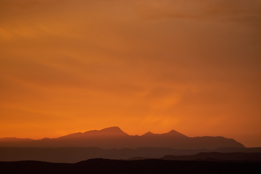 silhouette of mountains under blue sky during daytime