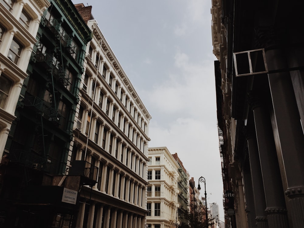 brown concrete building under white clouds during daytime