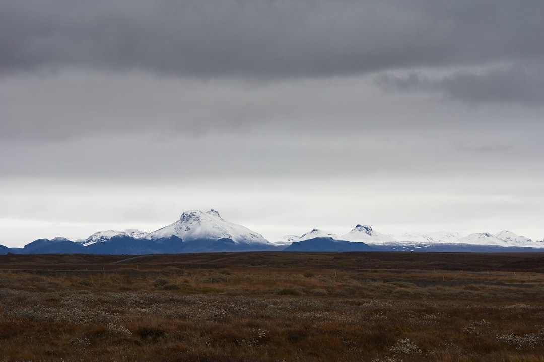 white clouds over snow covered mountains