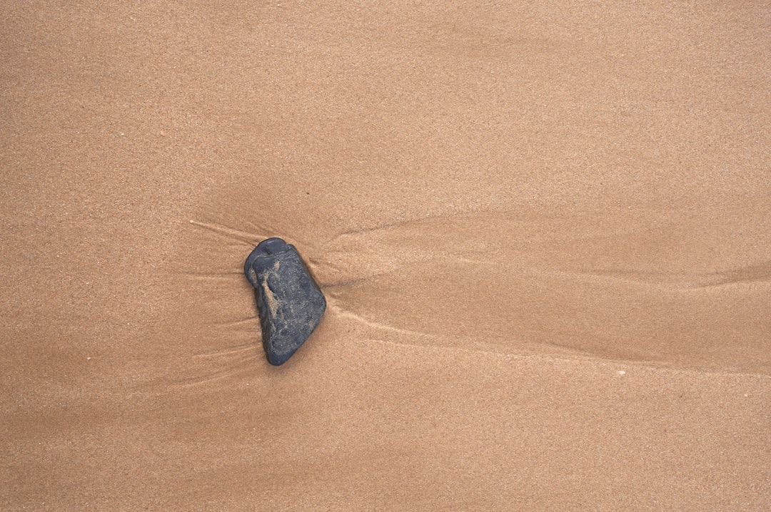 black stone on brown sand