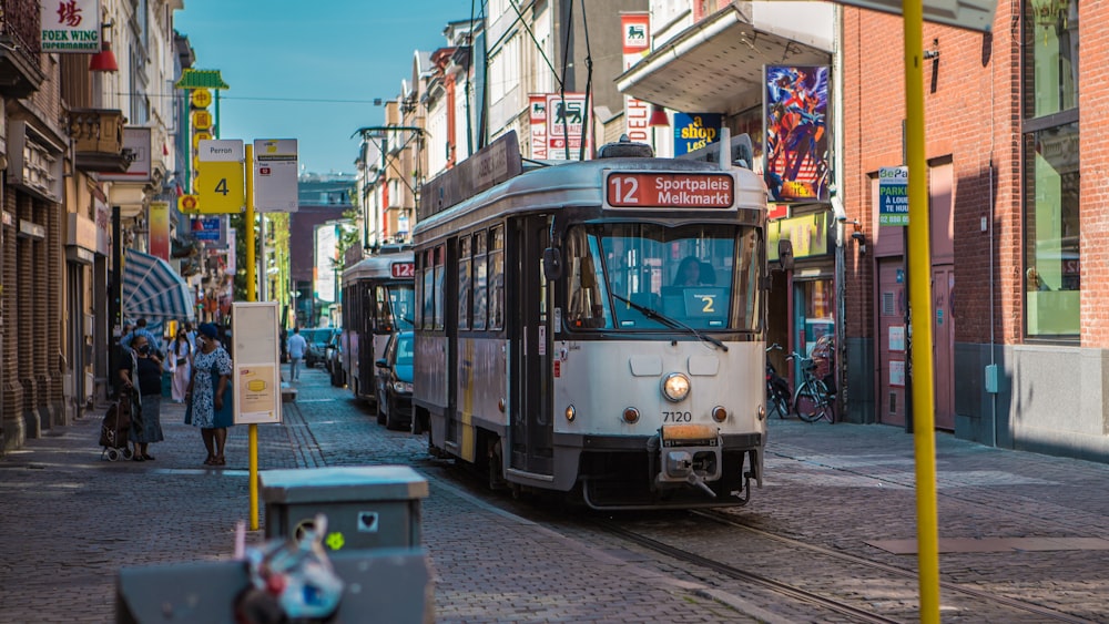 white and green tram on road during daytime