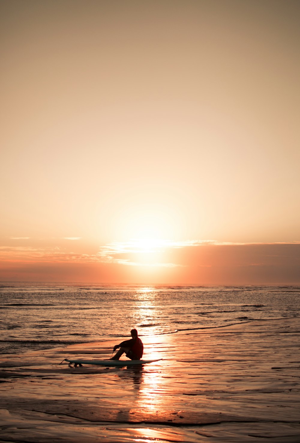 silhouette of man riding on boat during sunset