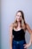 woman in black tank top smiling