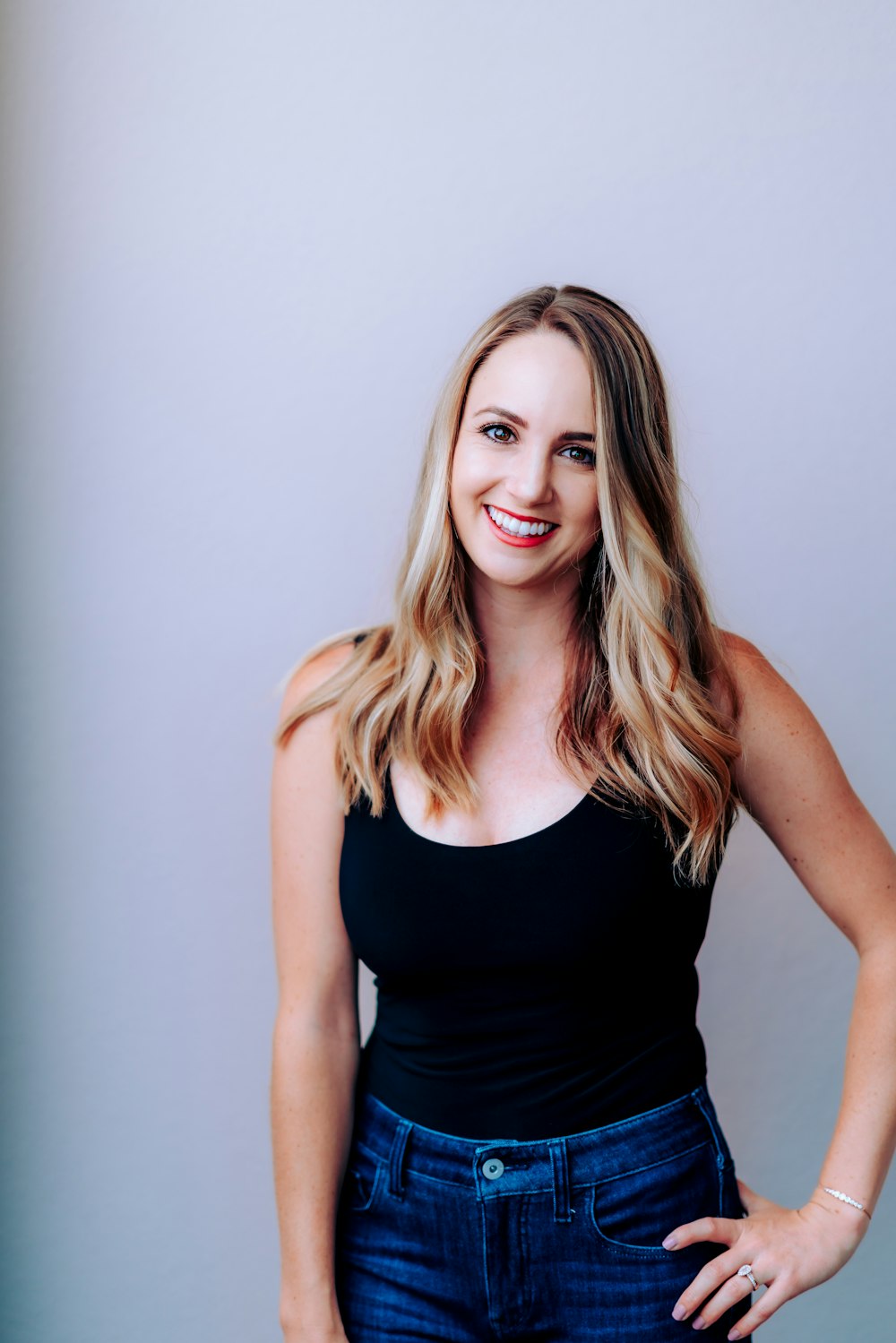 woman in black tank top smiling