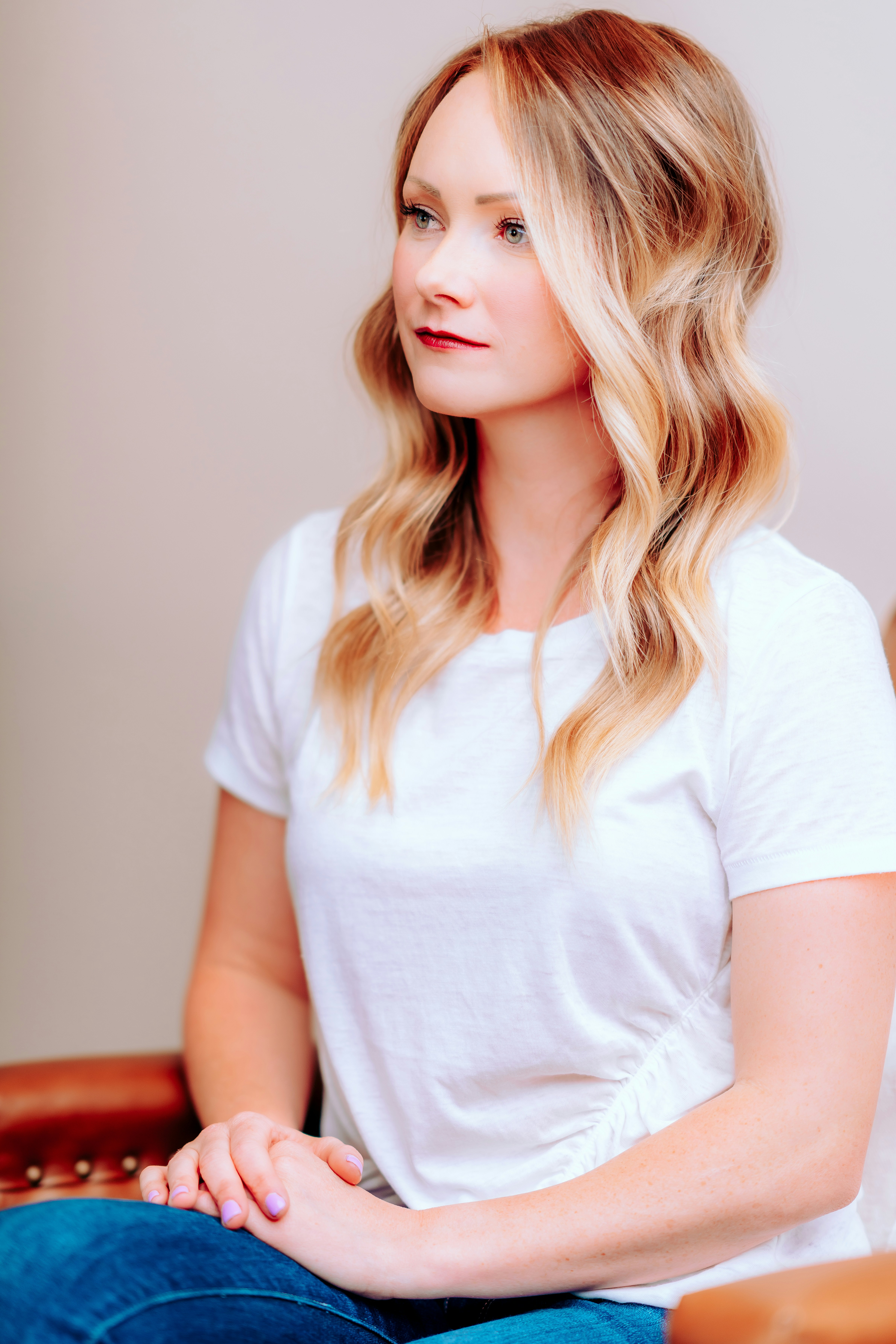 a stunning model with voluminous, flowing hollywood-style hair extensions that cascade her face