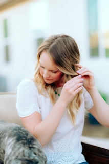 girl in white shirt sitting on white couch