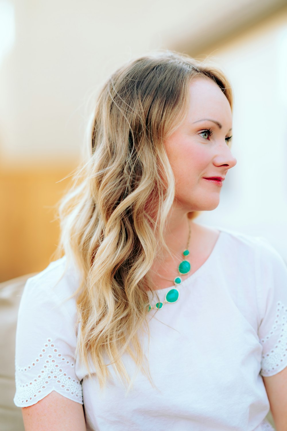 woman in white shirt with brown hair