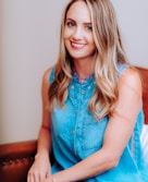 smiling girl in blue sleeveless dress